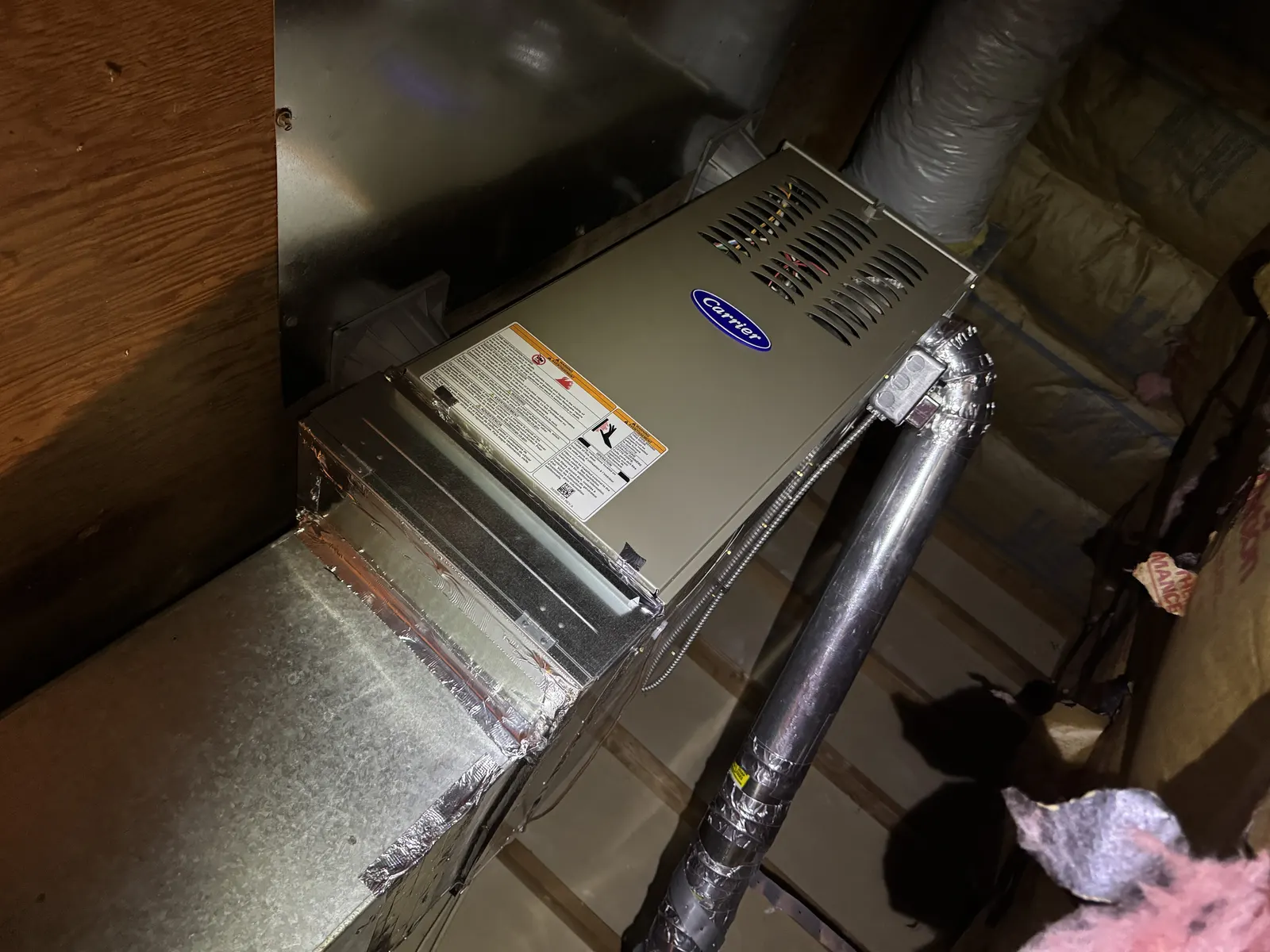 Carrier two-stage furnace installed in a Westside Los Angeles attic with rigid duct return and B-vent connection for safe combustion