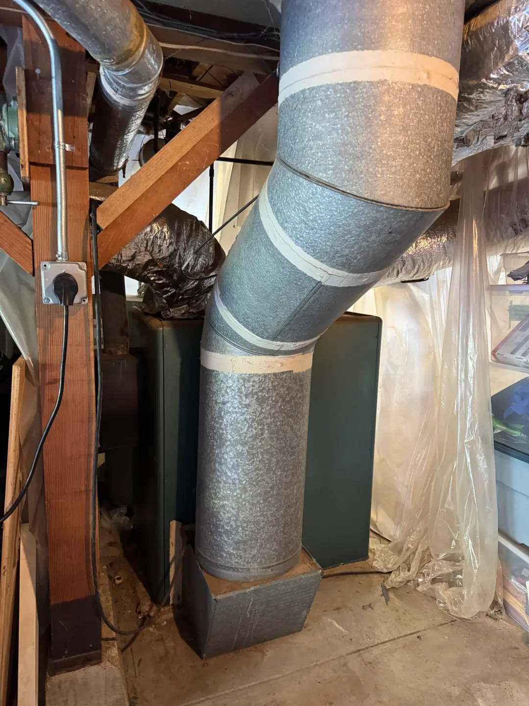 Galvanized round trunk duct connected to insulated flex branches in a West Los Angeles attic during HVAC system retrofit